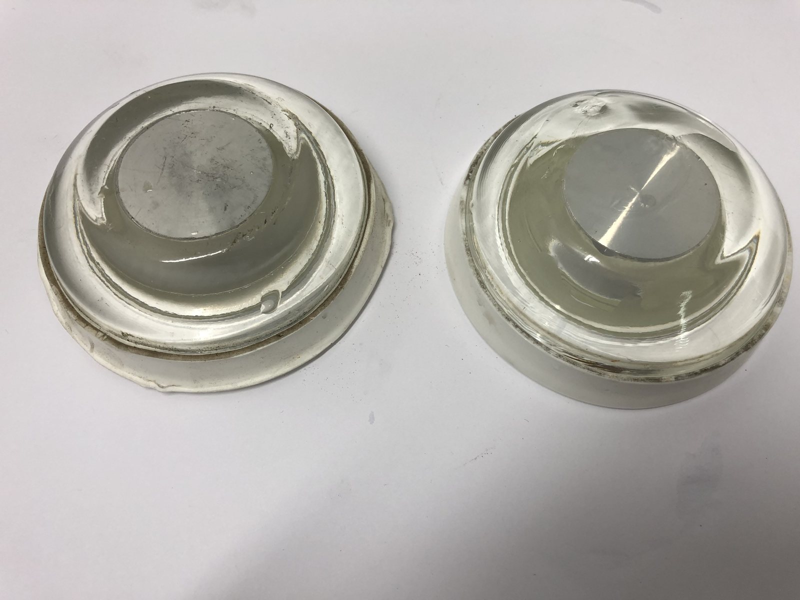 Two sizes of airfield light lens as received, deposit on the centre optic