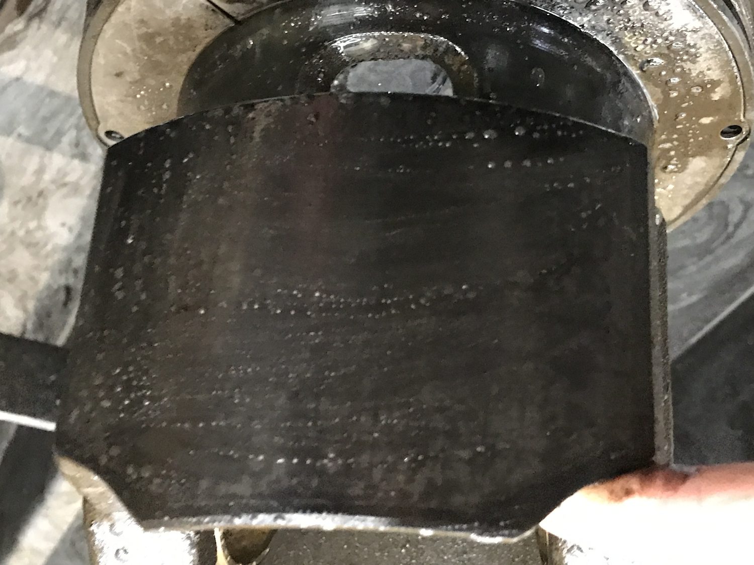 Large-bore diesel piston skirt and crown covered in baked carbon