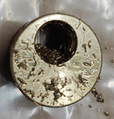 Casing bore packed with oil-bound swarf — the retained-chip failure waiting to happen.