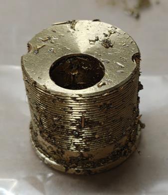 Brass lock plug with machining paste before cleaning