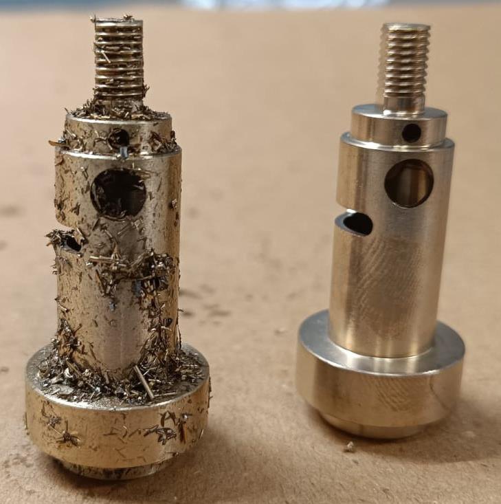 Lock stem pair — chips held on the thread and boss, and clean after the cycle.