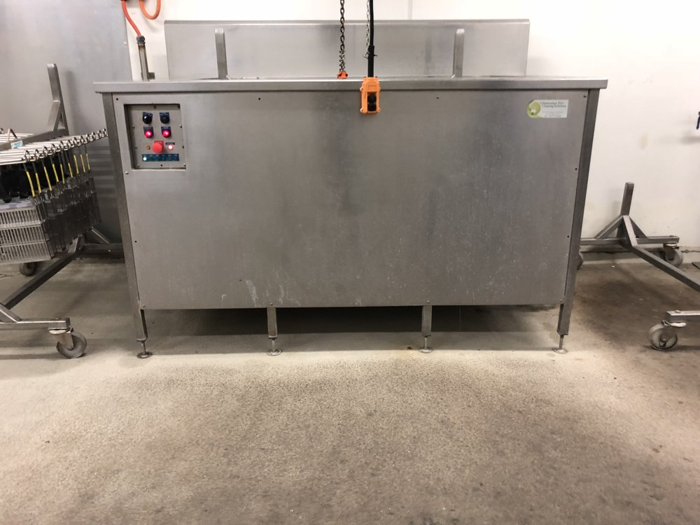 The industrial ultrasonic system installed at the plant — stainless construction for wash-down environment.