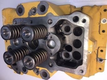 Cat cylinder head as received, carbon deposit over yellow paint