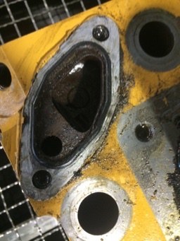 Exhaust port throat and flange face with baked carbon
