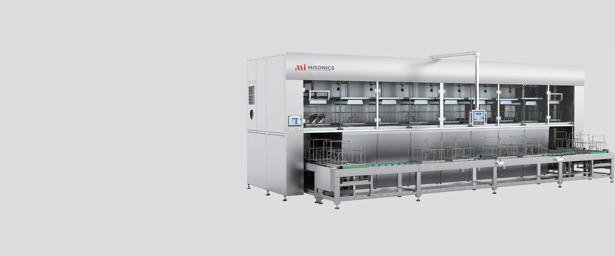 Misonics CM series multi-stage ultrasonic cleaning line — enclosed process stages above, conveyor transport running the length of the machine below