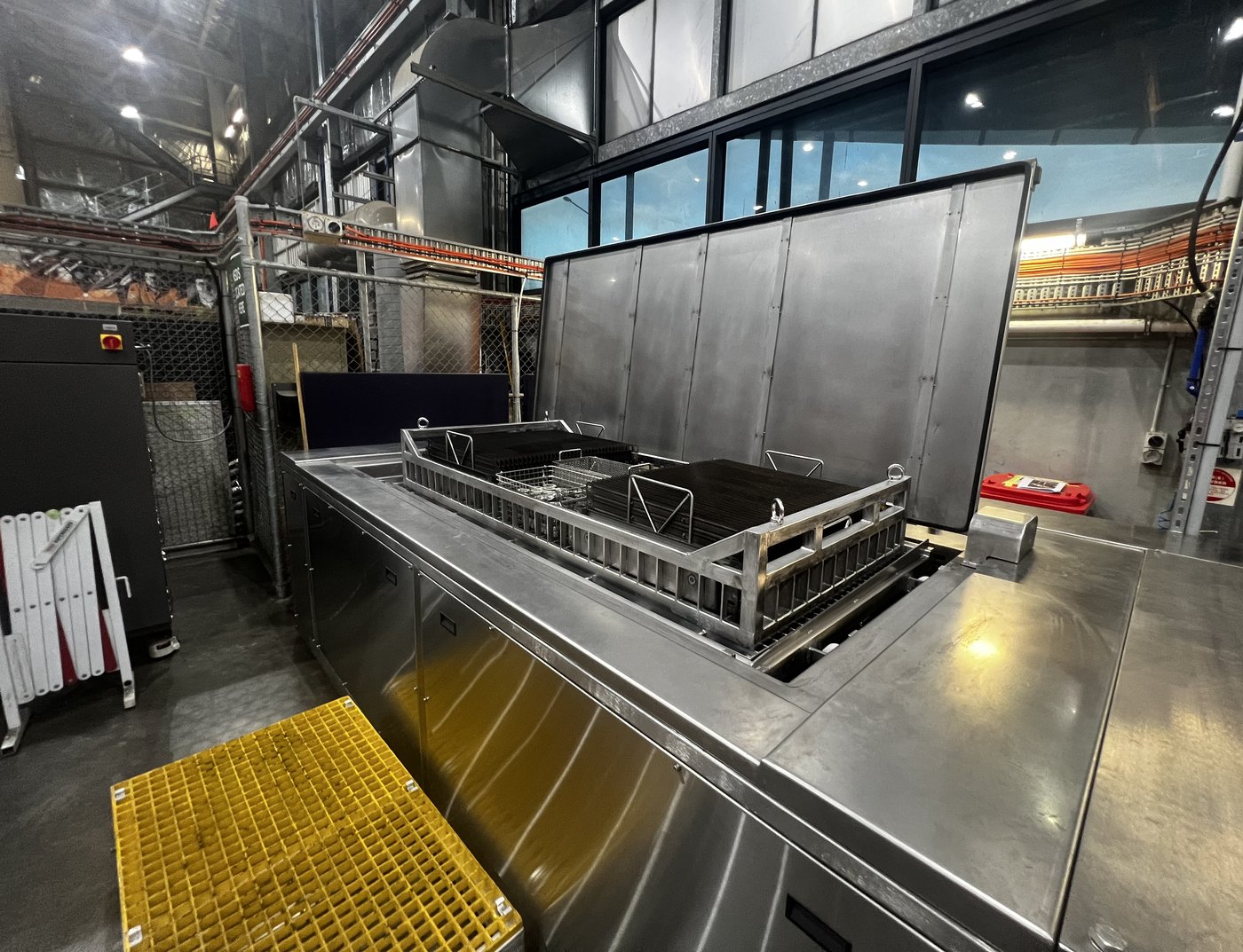 EVS 1500-PL platform raised — loaded baskets draining over the bath