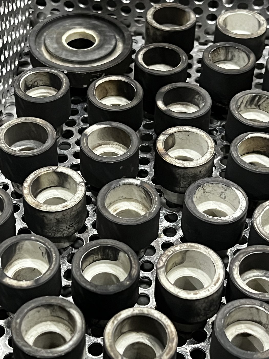Carbon-fouled components before ultrasonic cleaning