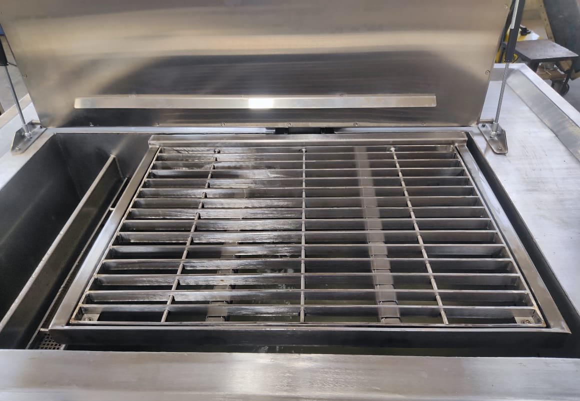 EVS 300 industrial ultrasonic cleaning tank with the lid open, showing the bath, weir and basket rails