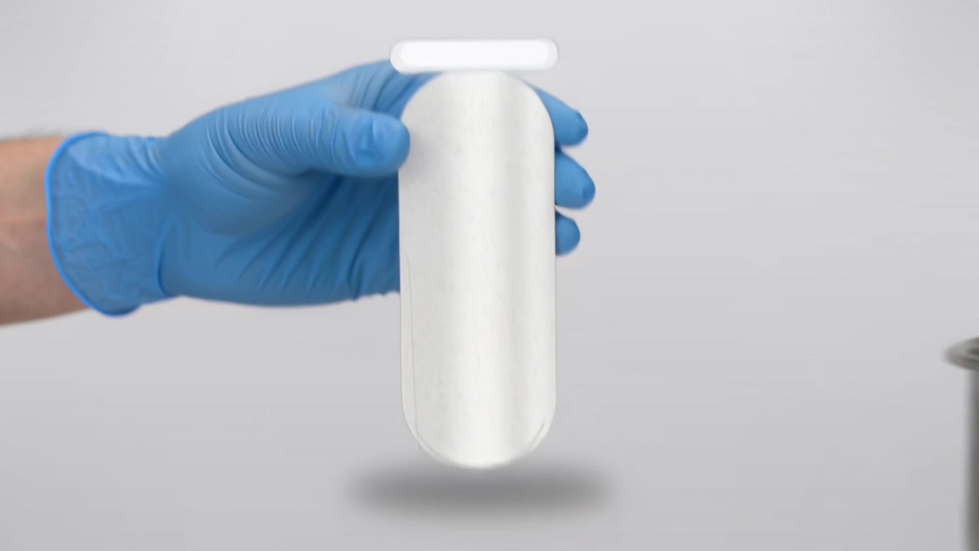 Technician handling a polypropylene filter bag before fitting it to the housing