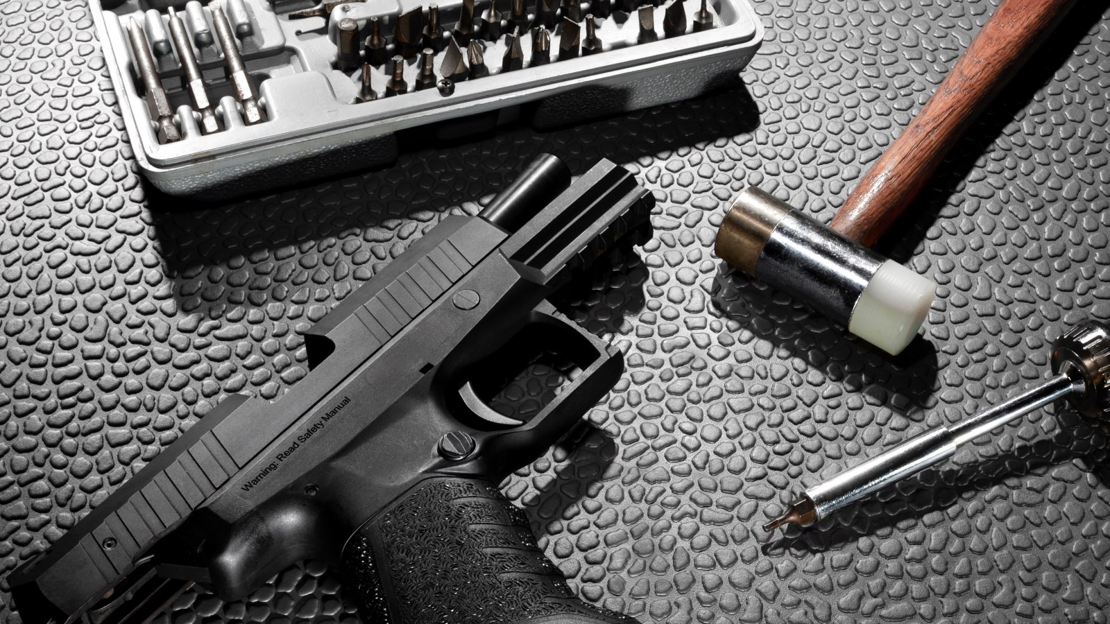 Armourer's bench with service pistol and maintenance tools