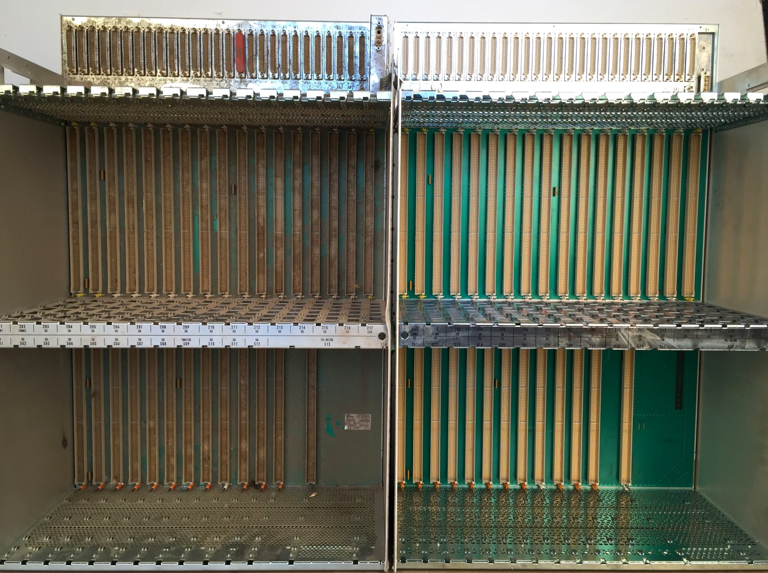 Telecom exchange subracks, fouled and cleaned, in one frame