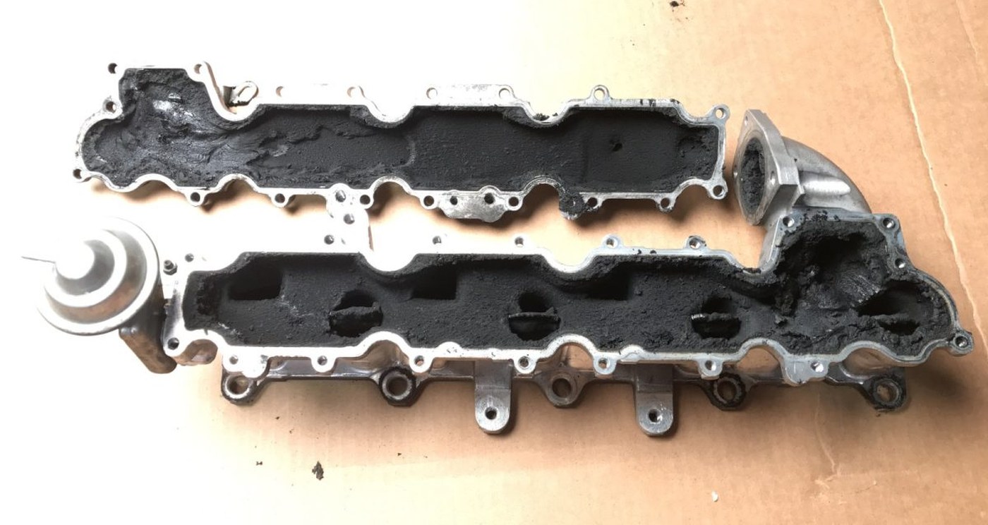 A pair of diesel inlet manifolds photographed as received, before any process