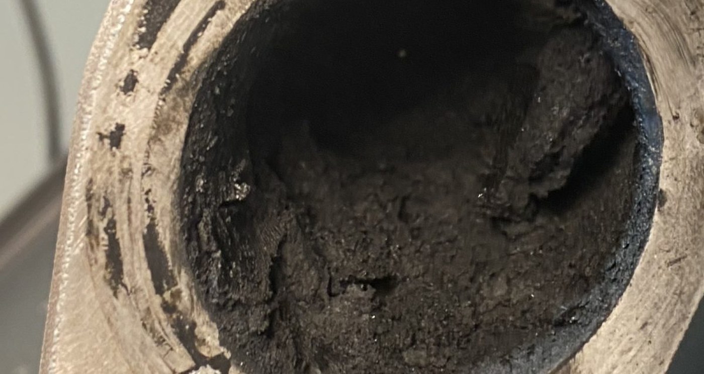 Baked carbon inside a manifold inlet port bore