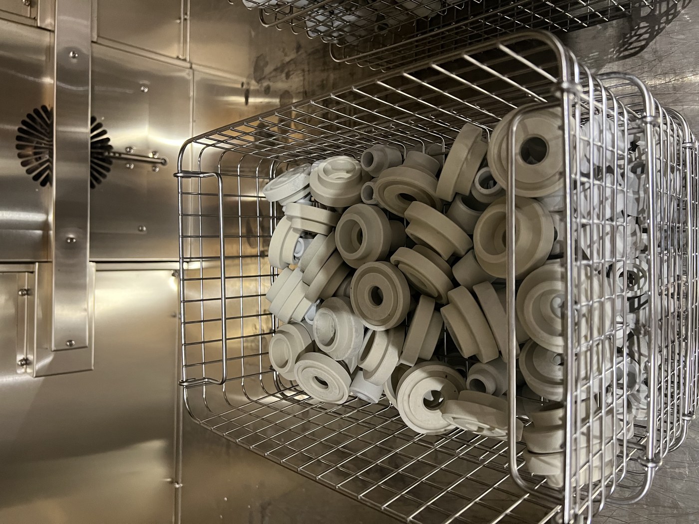 Ceramic insulator rings loaded in a stainless basket inside the tank