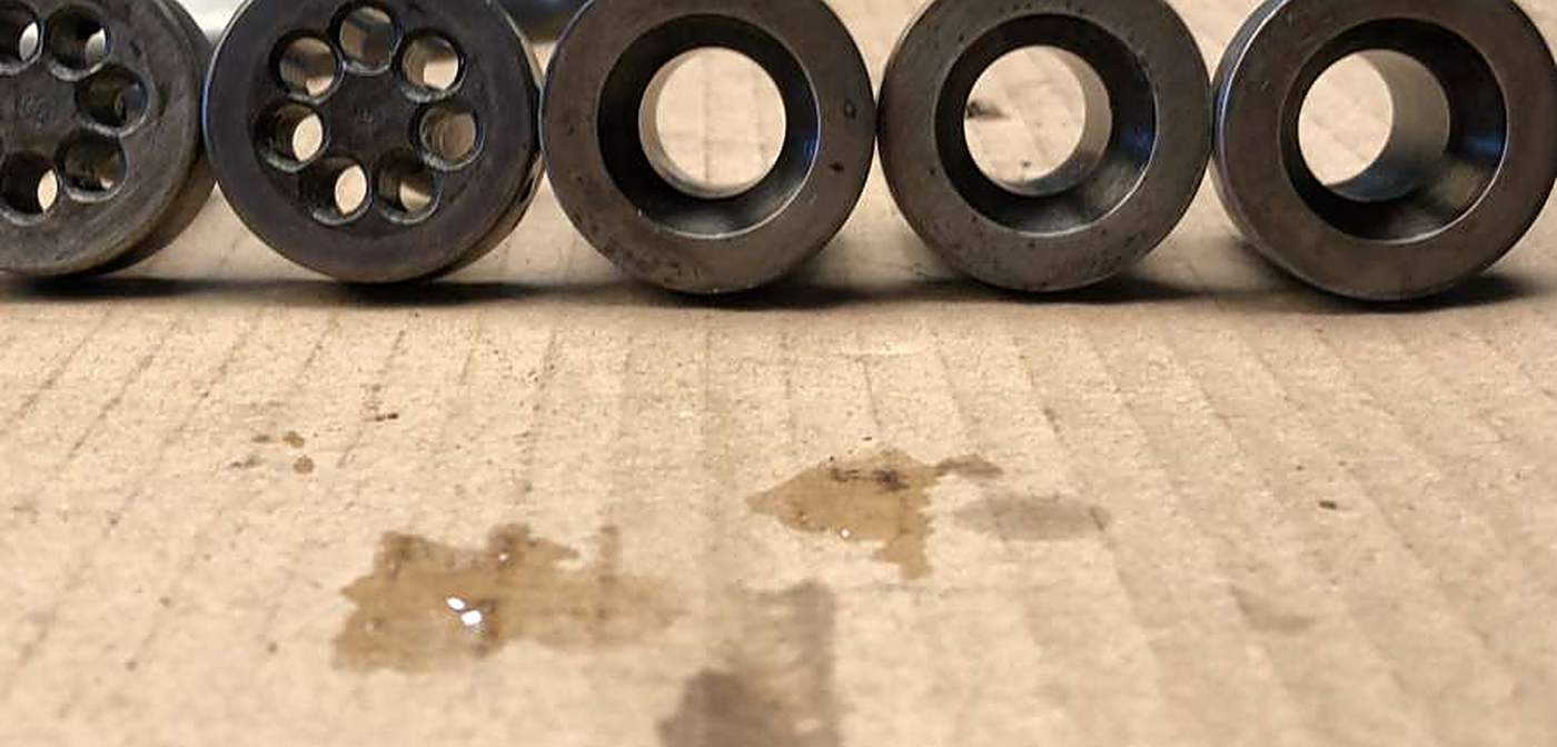 A row of food extrusion dies part-way through a documented cleaning trial in the Misonics laboratory