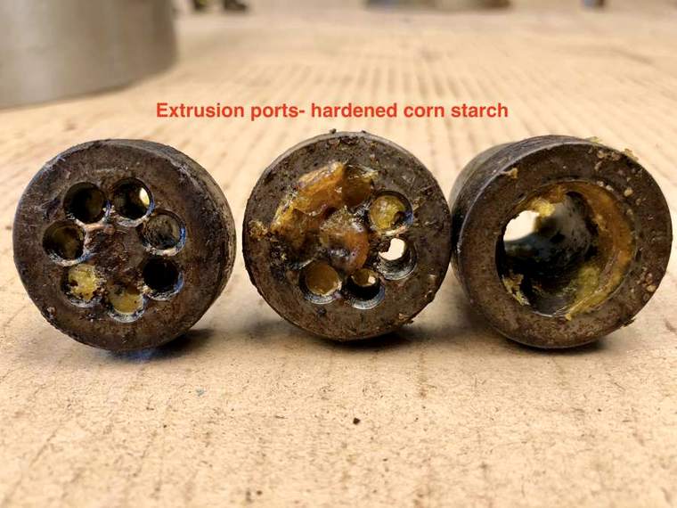 Extrusion dies as received, ports blocked with hardened corn starch