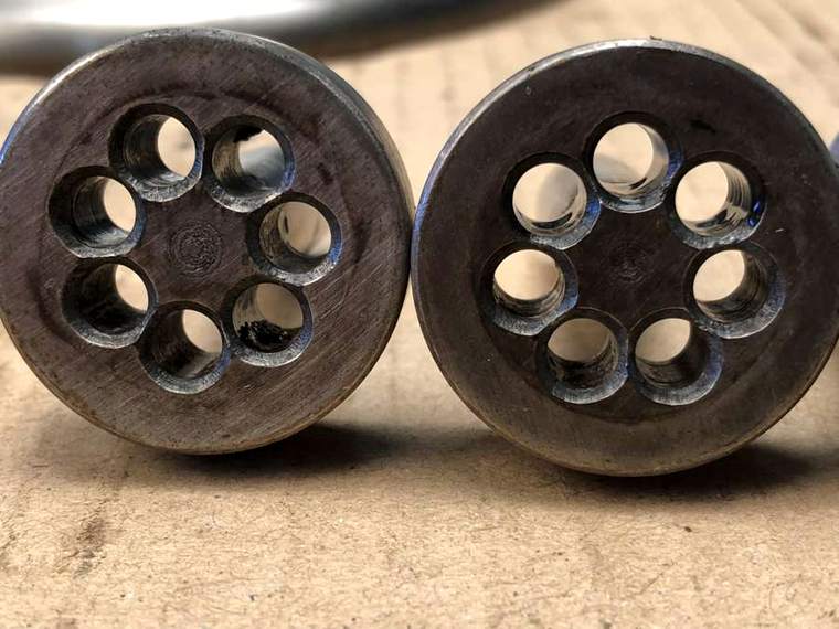 Cleaned extrusion dies with every port open and bright metal visible