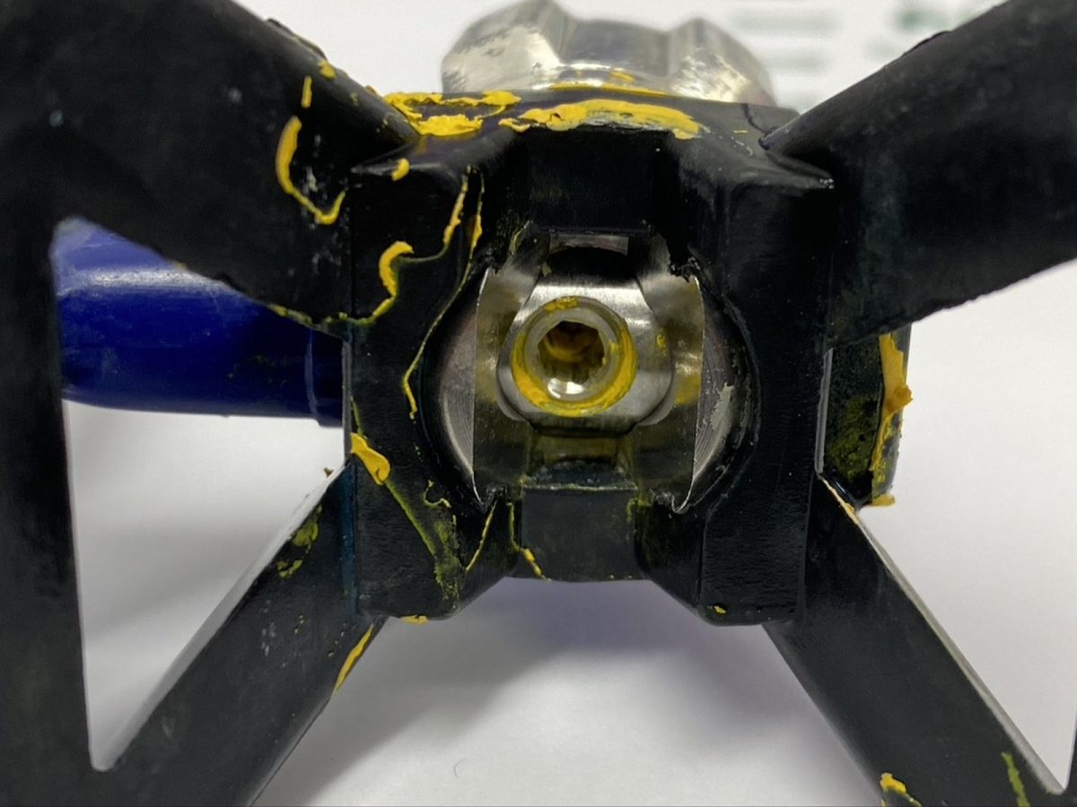 Airless tip and guard — before and after ultrasonic cleaning — as received