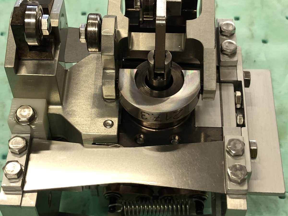 Cam and plate detail — before and after ultrasonic cleaning — after the cycle