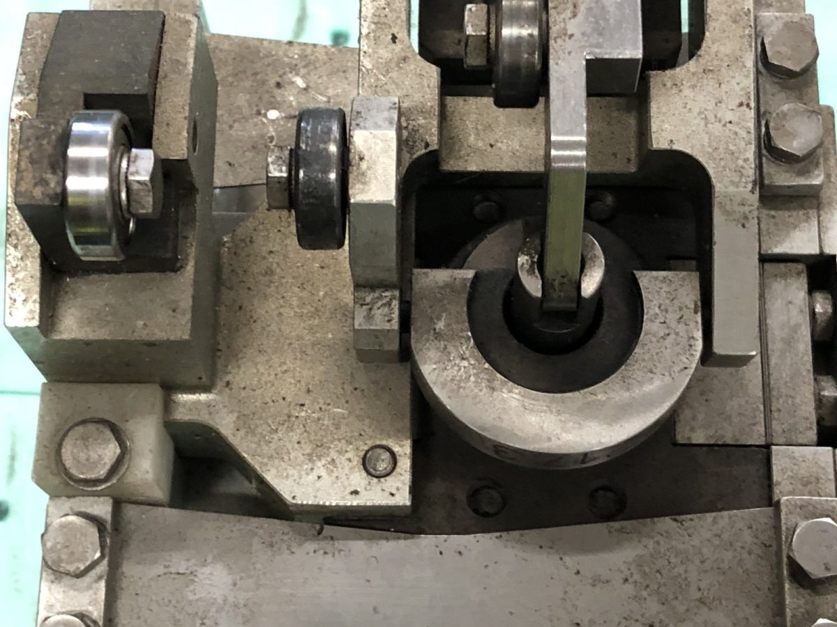 Cam and plate detail — before and after ultrasonic cleaning — as received