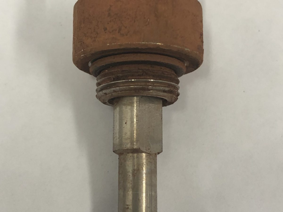 Mine-site dust suppression nozzle sheathed in mineral scale