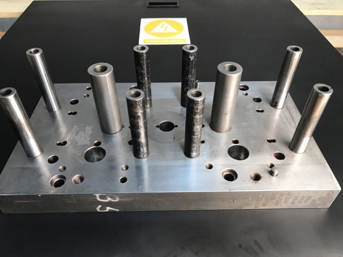 Ejector pins in a die plate — before and after ultrasonic cleaning — after the cycle