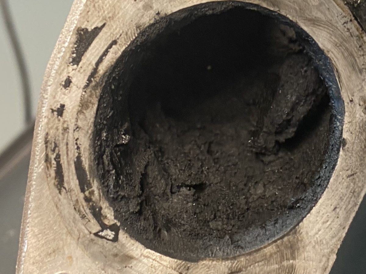 Manifold flange port — before and after ultrasonic cleaning — as received