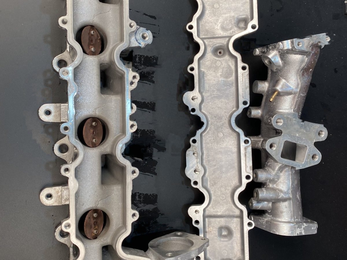 A pair of manifolds, as received — before and after ultrasonic cleaning — after the cycle