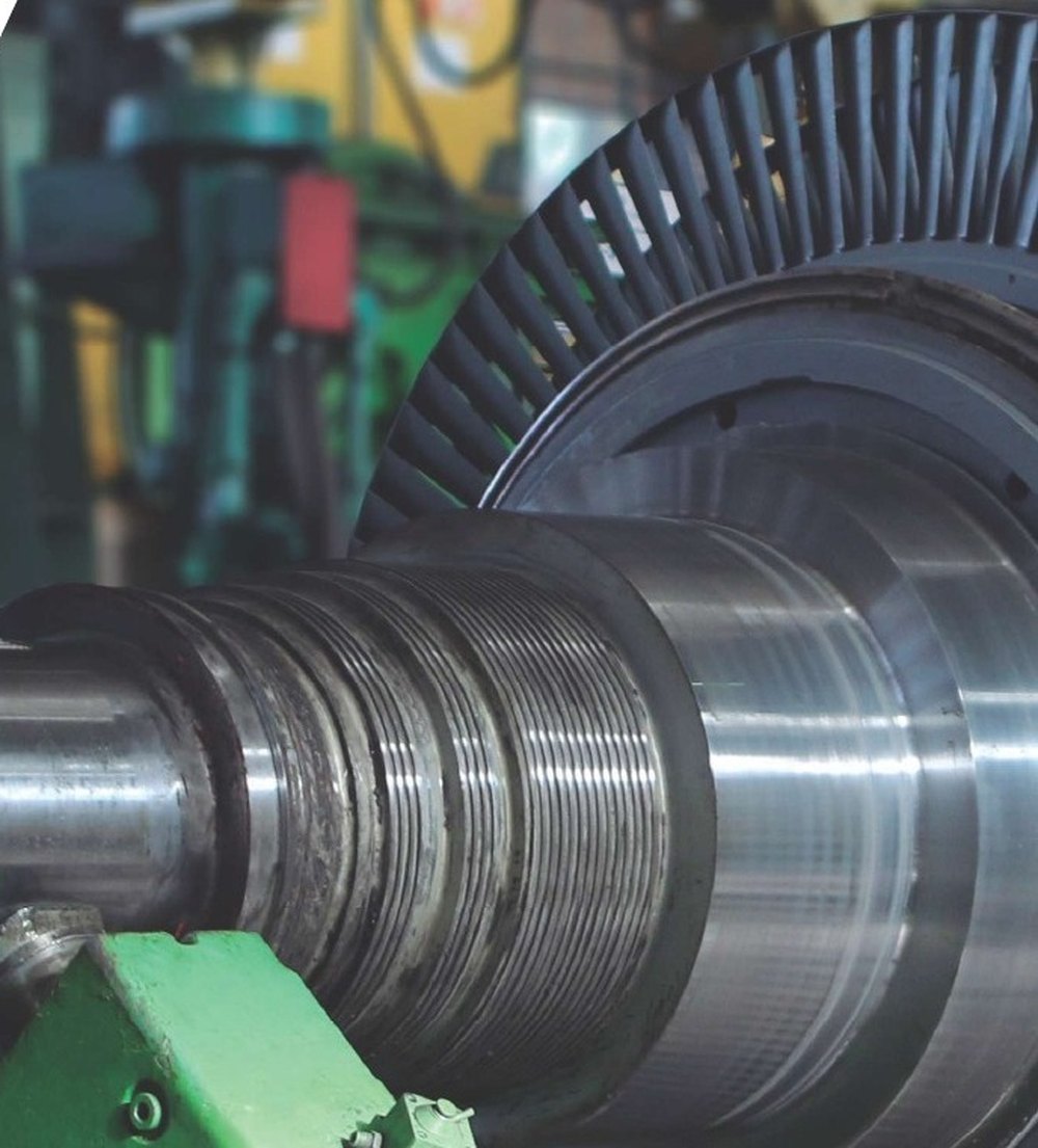 A steam turbine rotor on a workshop bed, the kind of component an UltraTecno machine is sized around