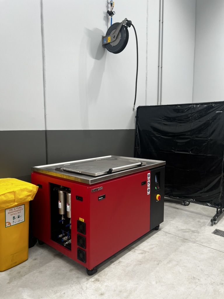MSX 240 ultrasonic tank at a truck service centre, with the filter housings behind the open lower panel